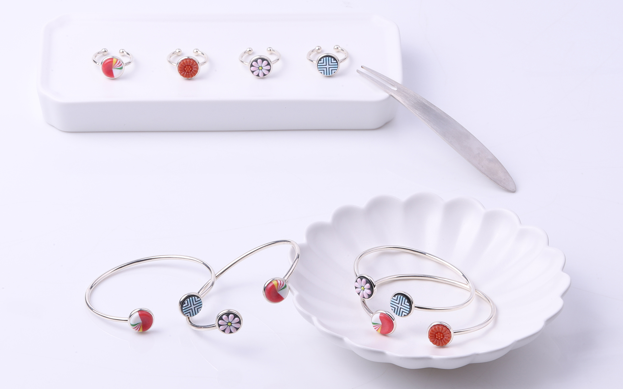 Dagwa collection necklaces, rings, and bracelets with colorful motifs